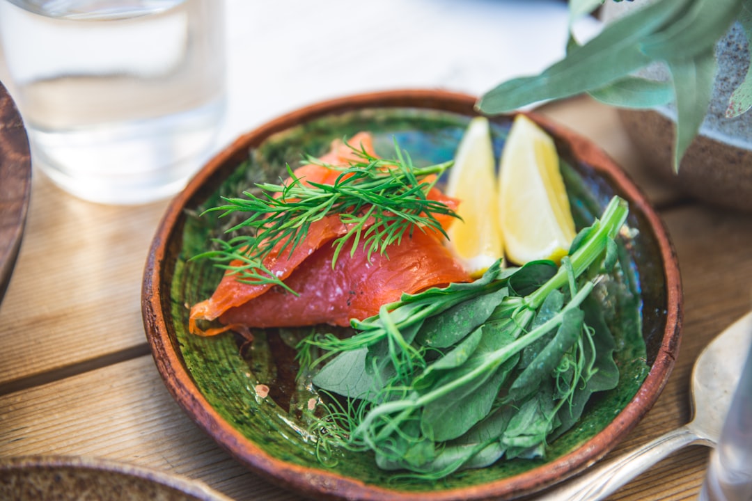 Colorful salmon bowl with rice topped with fresh microgreens and vegetables