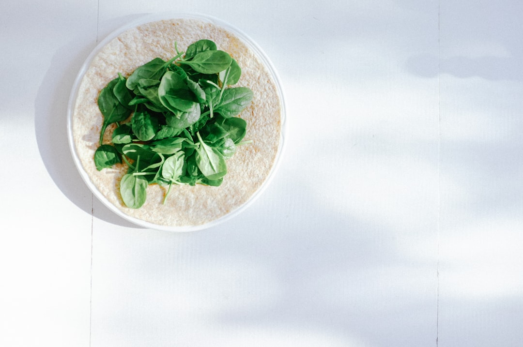 Colorful breakfast burrito cut in half showing eggs, microgreens, and fillings