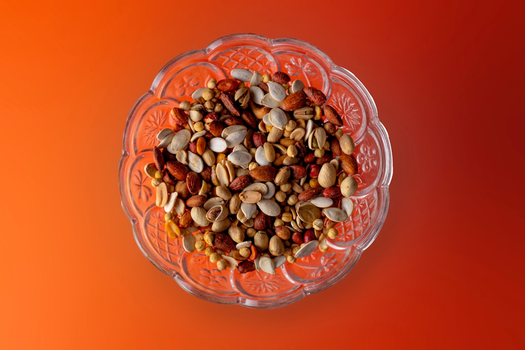 Colorful quinoa grain bowl topped with fresh microgreens and drizzled with tahini dressing