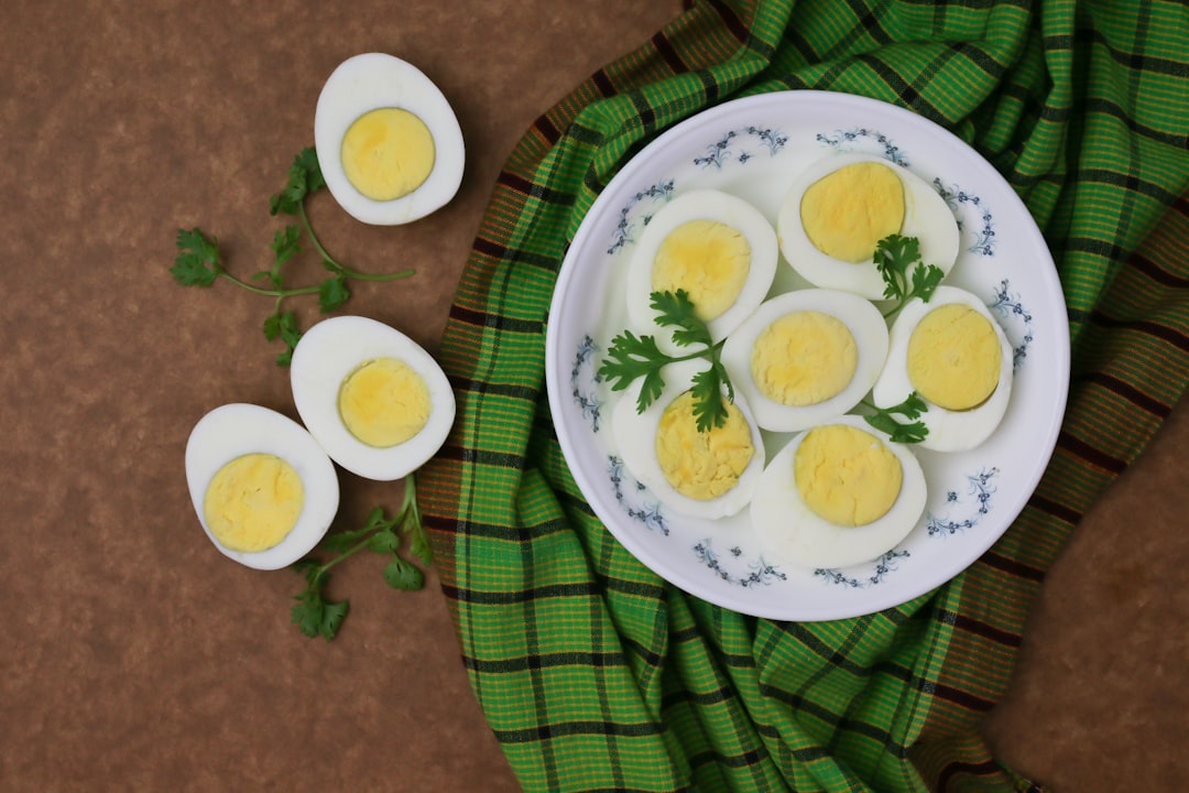 Golden fluffy omelet filled with colorful microgreens and melted cheese on white plate