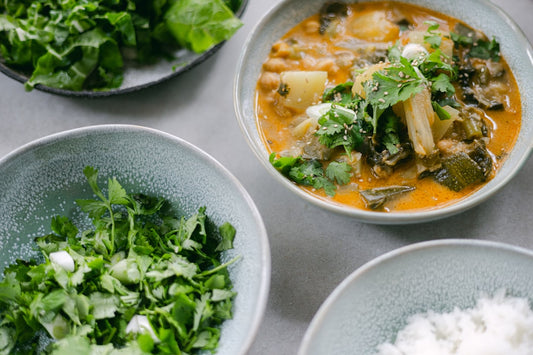 a table topped with bowls of food and rice