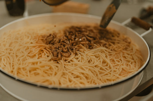 Golden toasted bruschetta topped with diced tomatoes, fresh basil, and colorful microgreens on rustic wooden board