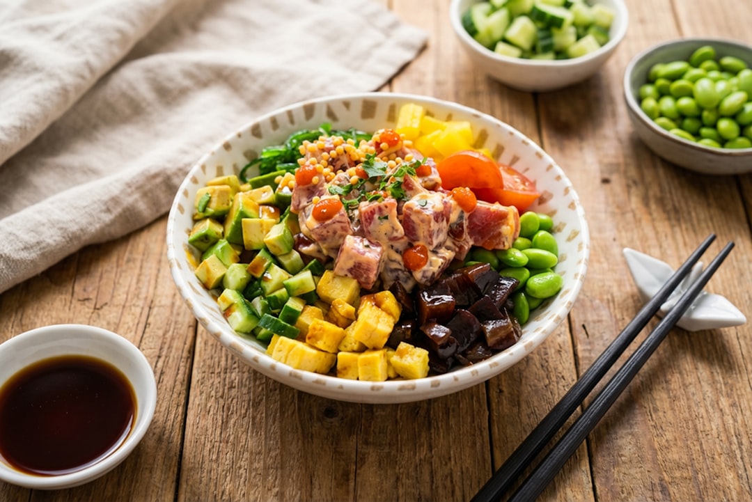 Colorful tuna poke bowl topped with fresh radish microgreens and avocado