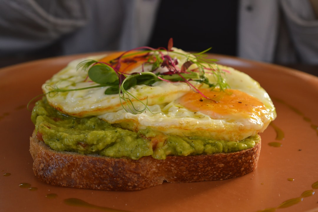 Colorful microgreens arranged on sandwich ingredients including bread, vegetables, and spreads